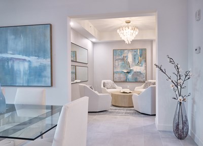 Image of the Coquina Sitting Room with neutral tones and blue accents.