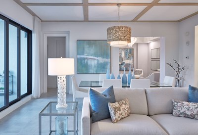 Image of the Coquina Living Room with neutral tones and blue accents.