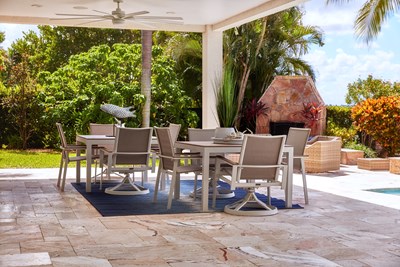 Two neutral outdoor dining tables, with view of the lounge area.