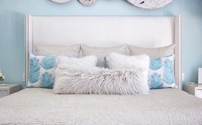 Blue & White bedroom pillows with palm print and faux fur.