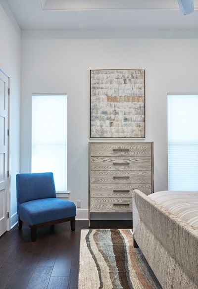 Neutral coastal bedroom with, brown and light blue color palette.