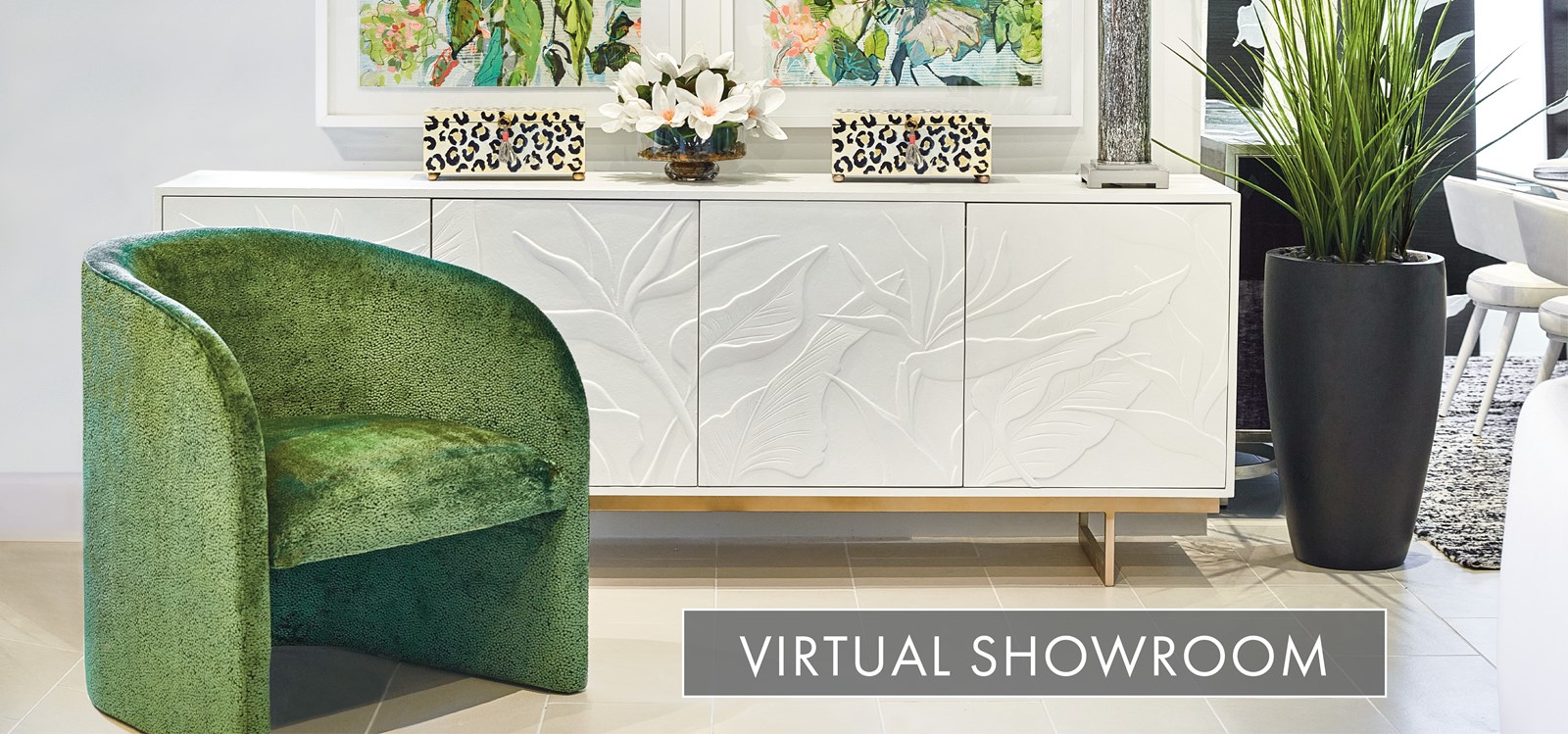 Image of a green accent chair in front of white console with leaf motif in Naples Showroom. Text: Virtual Showroom. Links to Virtual Showroom.