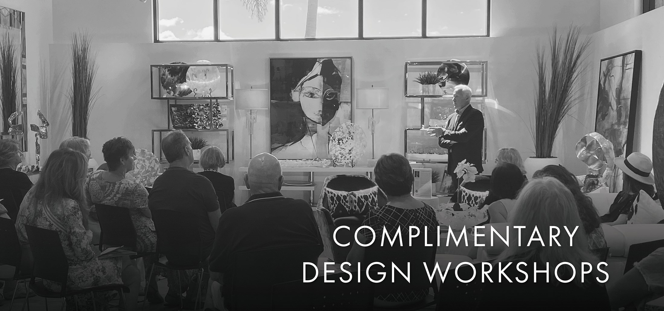 Image of a presenter at a design workshop. Text: Complimantary Design Workshops. Links to events page.