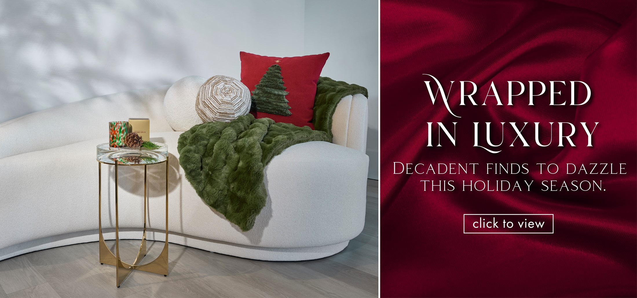 Image of a chaise decorated with Holiday Pillows in red and green, with a gold accent table with a candle on top. Text: Wrapped In Luxury. Decadent Finds to Dazzle This Holiday Season. 